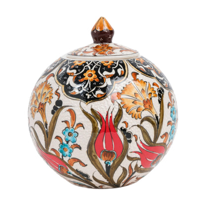 A hand-painted ceramic decorative jar with a lid, featuring red tulip motifs and other floral patterns in orange and blue on a white background.