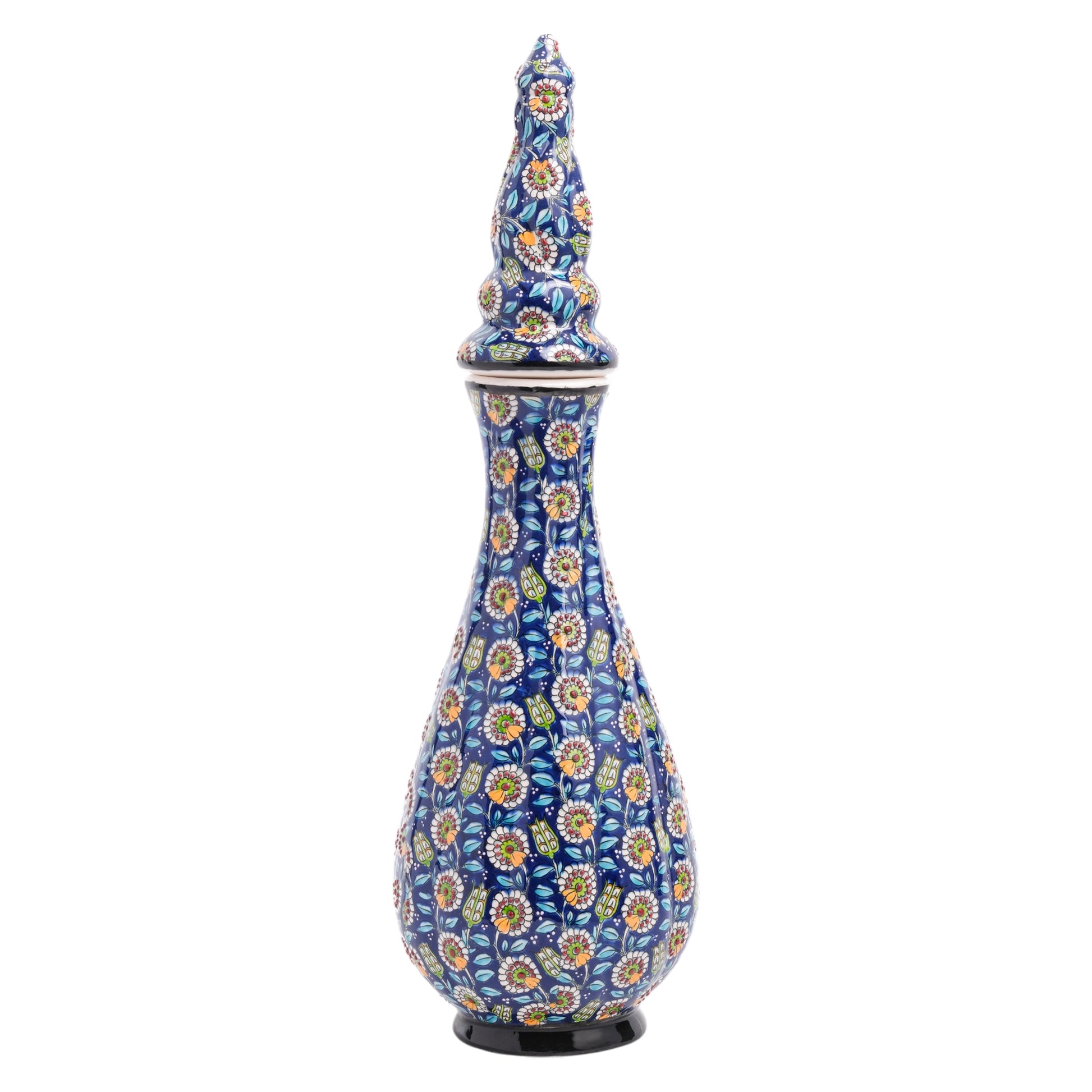 A handmade ceramic jar with a teardrop silhouette, featuring a navy blue base and vibrant floral patterns in white, yellow, and red, with a sculpted ornamental lid.
