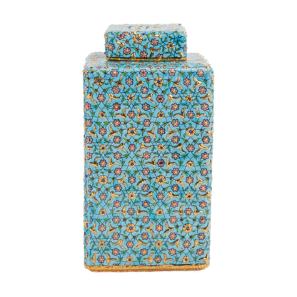 A turquoise ceramic square jar with a hand-painted golden blossom decorative pattern and a matching lid.