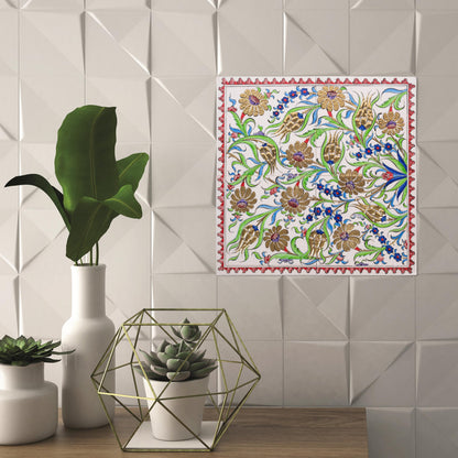 Decorative tablecloth with floral pattern next to potted plants and geometric decor on a ceramic tile