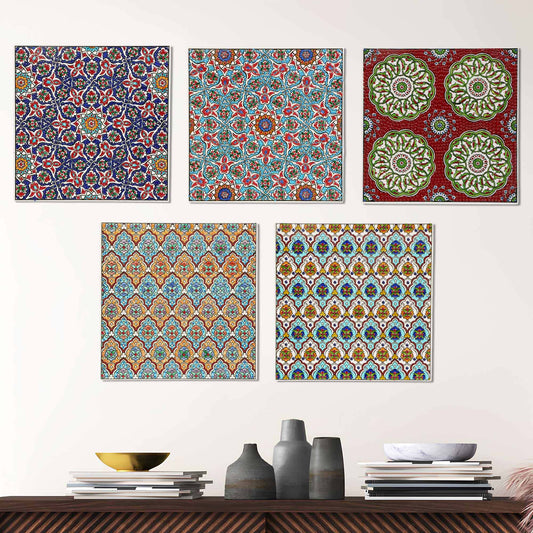 Set of five colorful patterned ceramic tile wall art pieces on a white wall above a wooden shelf with decorative items.