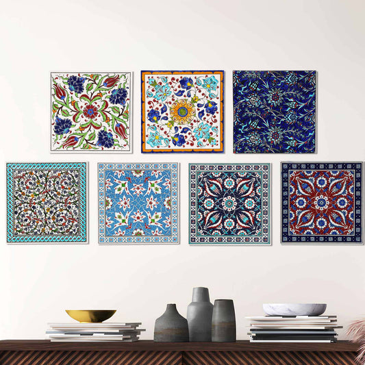 Set of colorful square ceramic tile wall art pieces on a white wall above a wooden shelf.