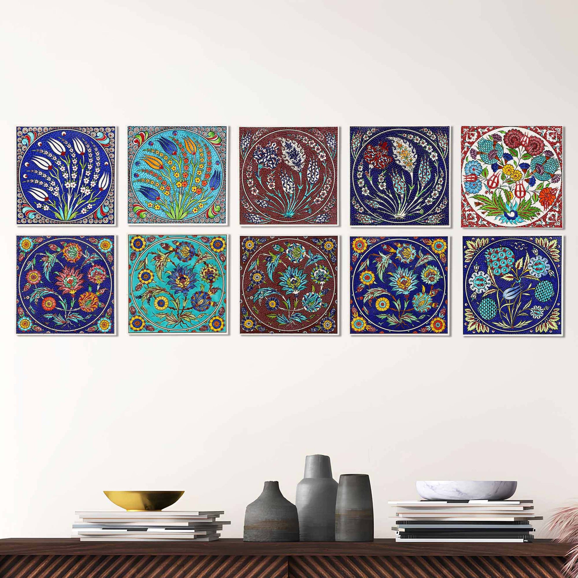 Decorative ceramic tiles with floral patterns on a wall above a wooden shelf.