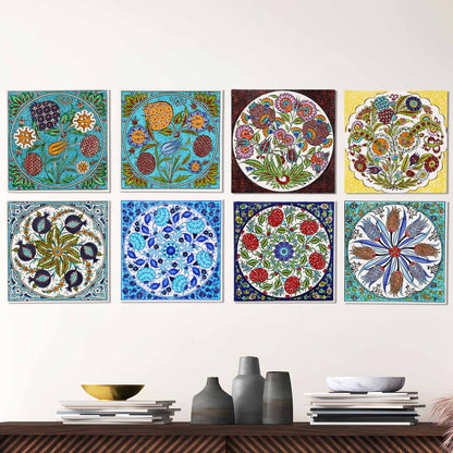 Set of colorful floral and geometric ceramic tiles on a wall above a wooden shelf with decorative items.