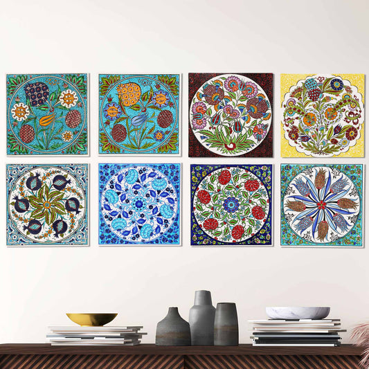 Set of colorful floral and geometric ceramic tiles on a wall above a wooden shelf with decorative items.