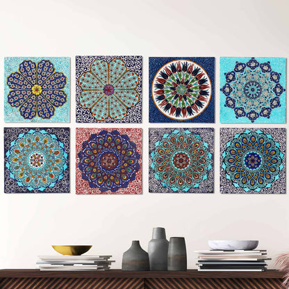 Set of colorful mandala-style ceramic tiles on a white wall above a wooden shelf with decorative items.