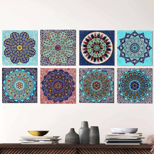 Set of colorful mandala-style ceramic tiles on a white wall above a wooden shelf with decorative items.