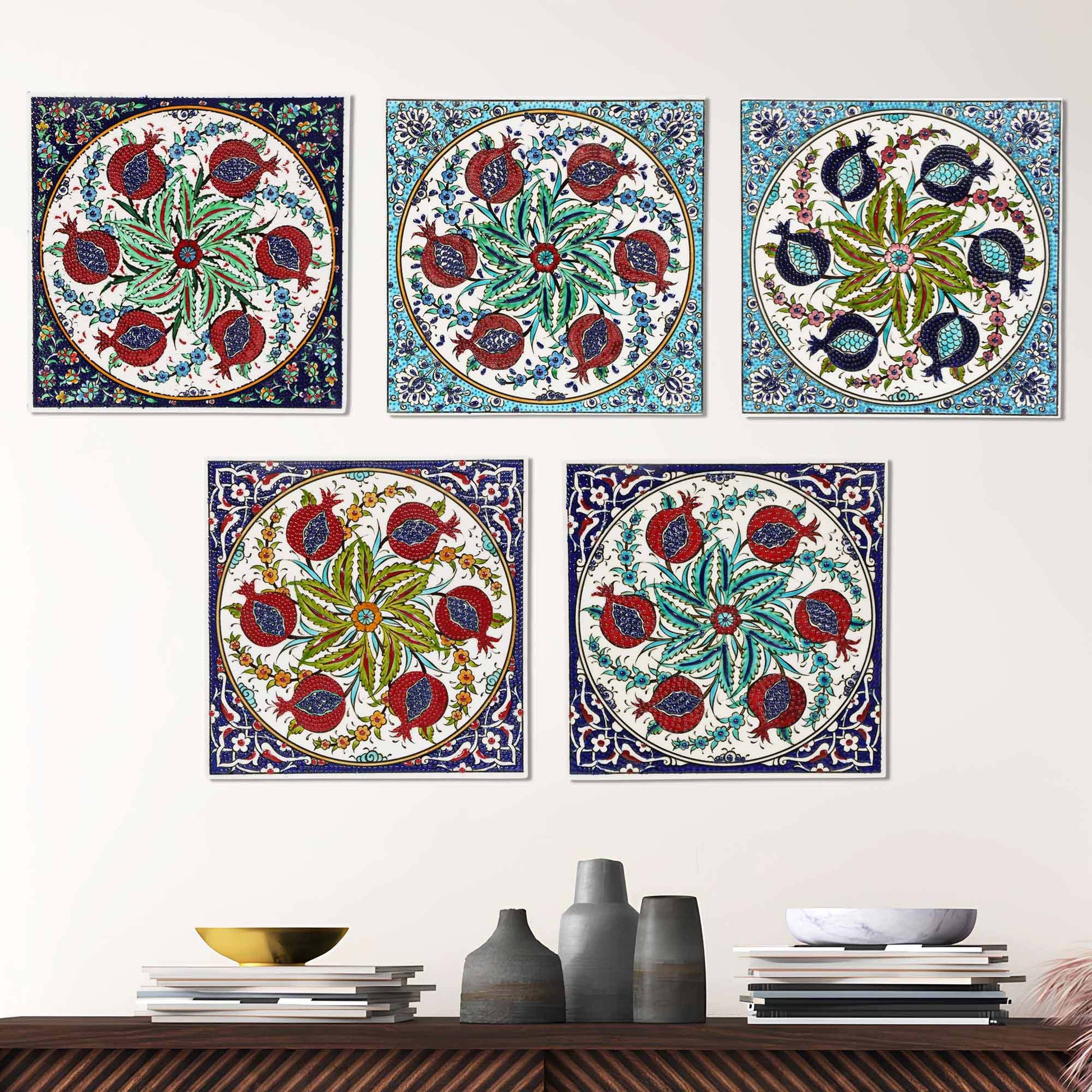 Colorful floral and pomegranate designs ceramic tiles on a wall above a wooden shelf with decorative items.
