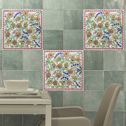 Decorative ceramic tiles with floral patterns on a green tiled wall.