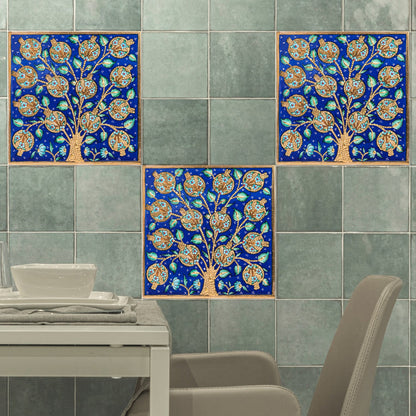 Decorative ceramic tiles with tree design on green tiles.