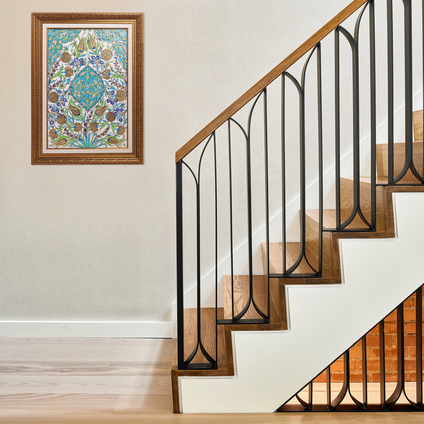 Staircase with black metal railing and ceramic tile in a home setting.