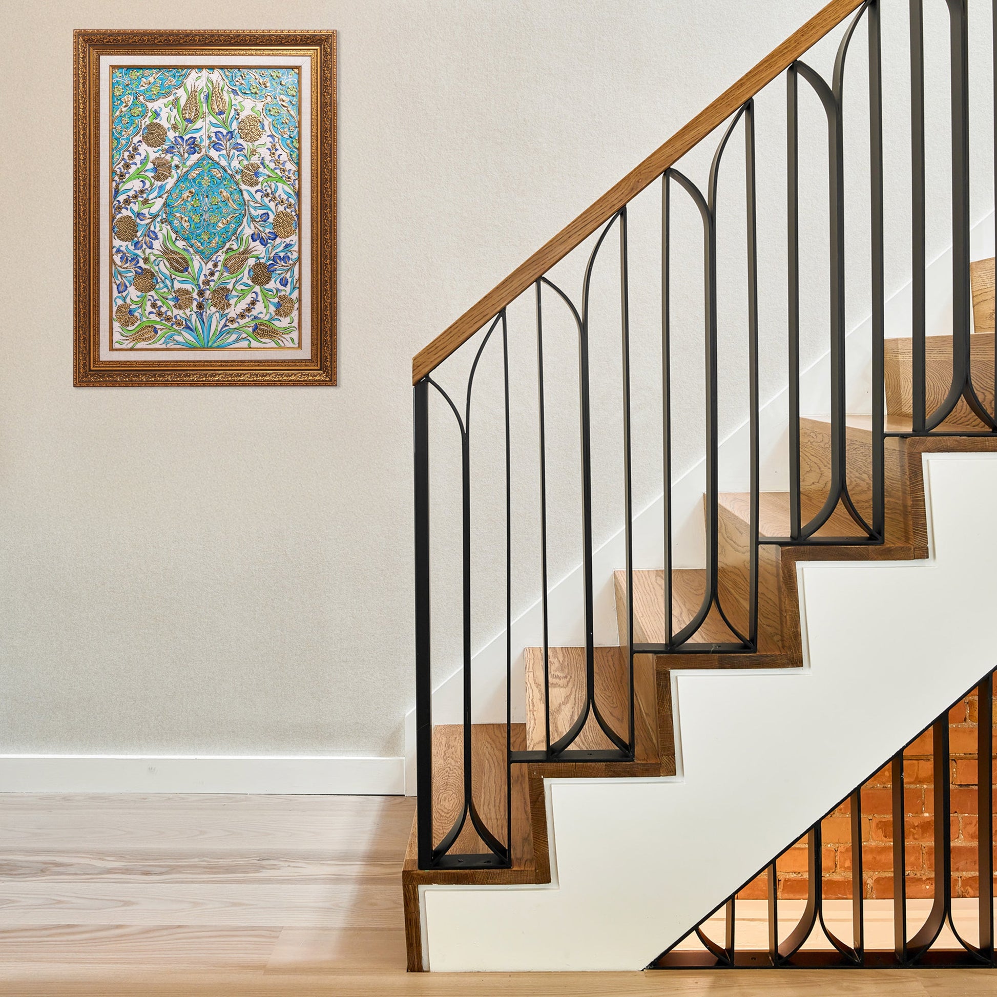 Staircase with black metal railing and ceramic tile in a home setting.