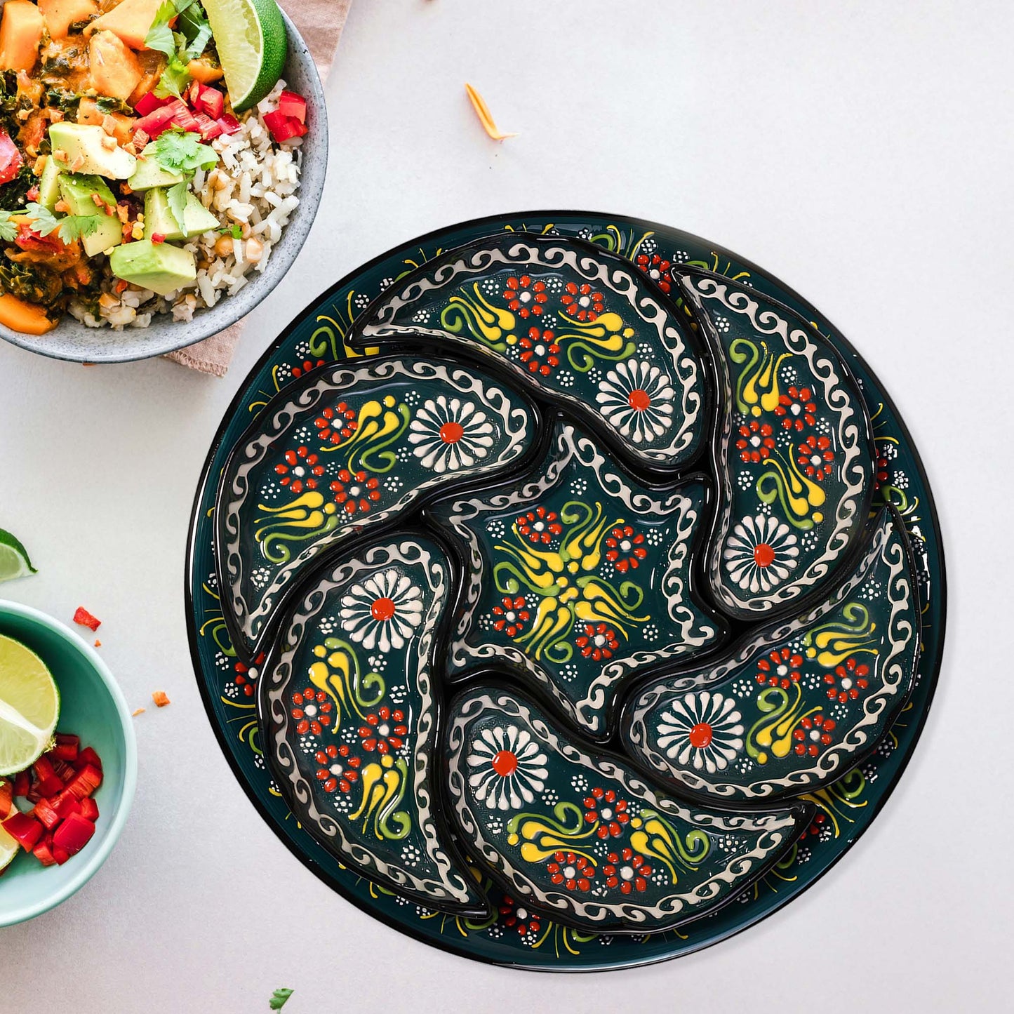 Decorative snack serving tray set with colorful patterns on a white surface with bowls of food.