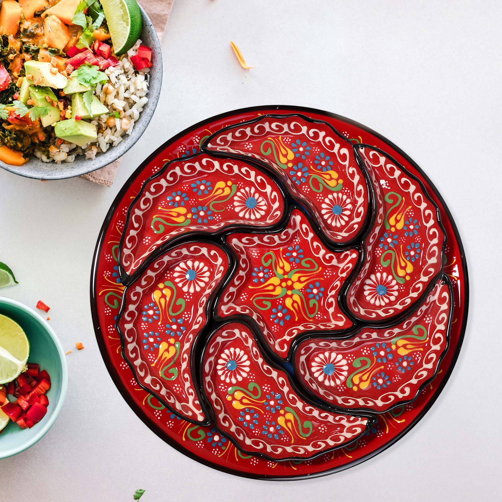 Decorative snack serving tray set with intricate paisley design on a white surface with bowls of food.