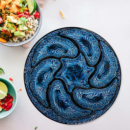 Blue decorative snack serving tray set with black patterns on a white surface with bowls of food.