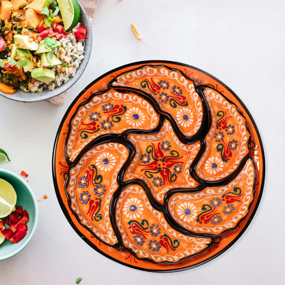Decorative snack serving tray set with intricate designs on a white surface with bowls of food.
