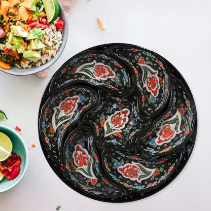 Decorative black snack serving trays with floral patterns on a white surface
