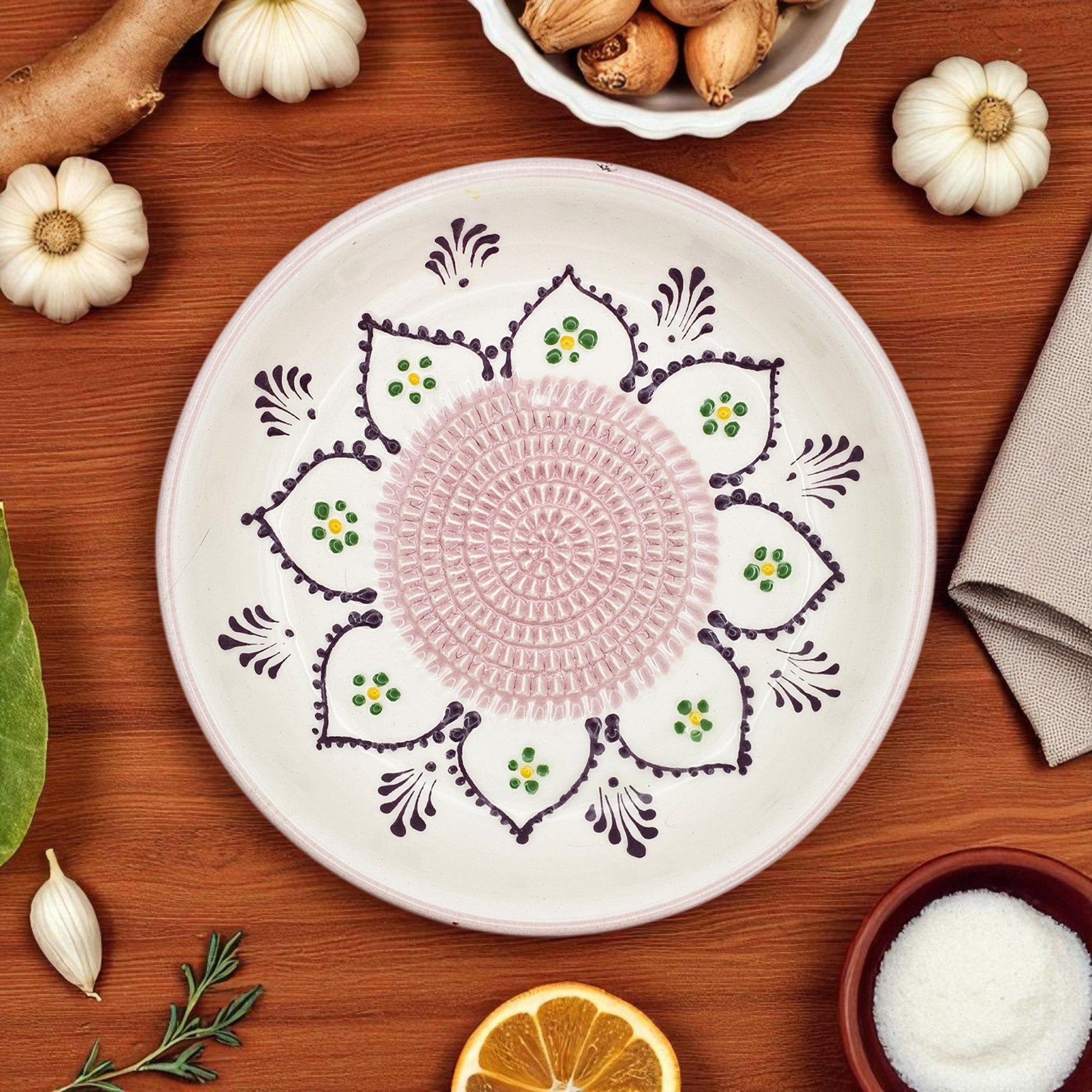 Decorative garlic grater bowl with intricate patterns on a wooden surface with pumpkins and other items.