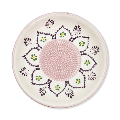 Decorative garlic grater bowl with pink center and floral patterns on a white background