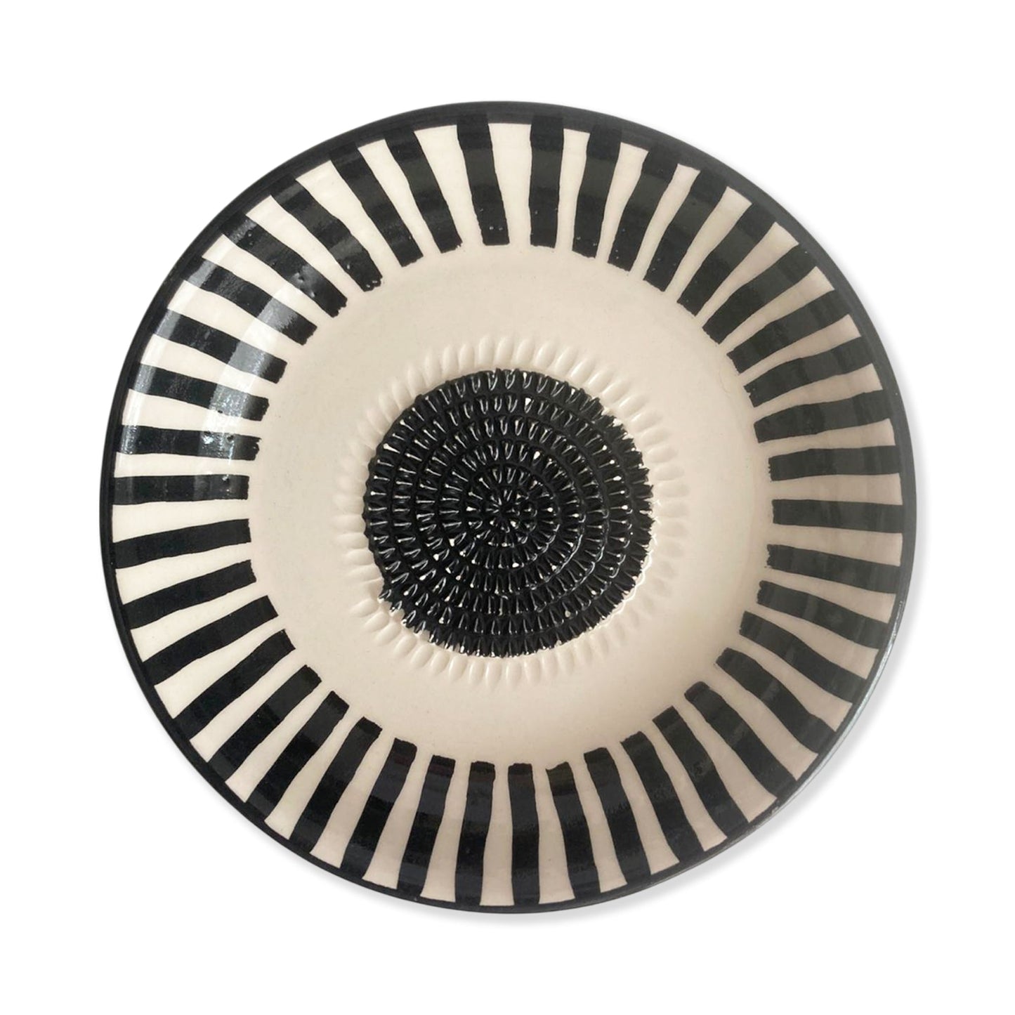Decorative garlic grater bowl with black and white striped design on a white background