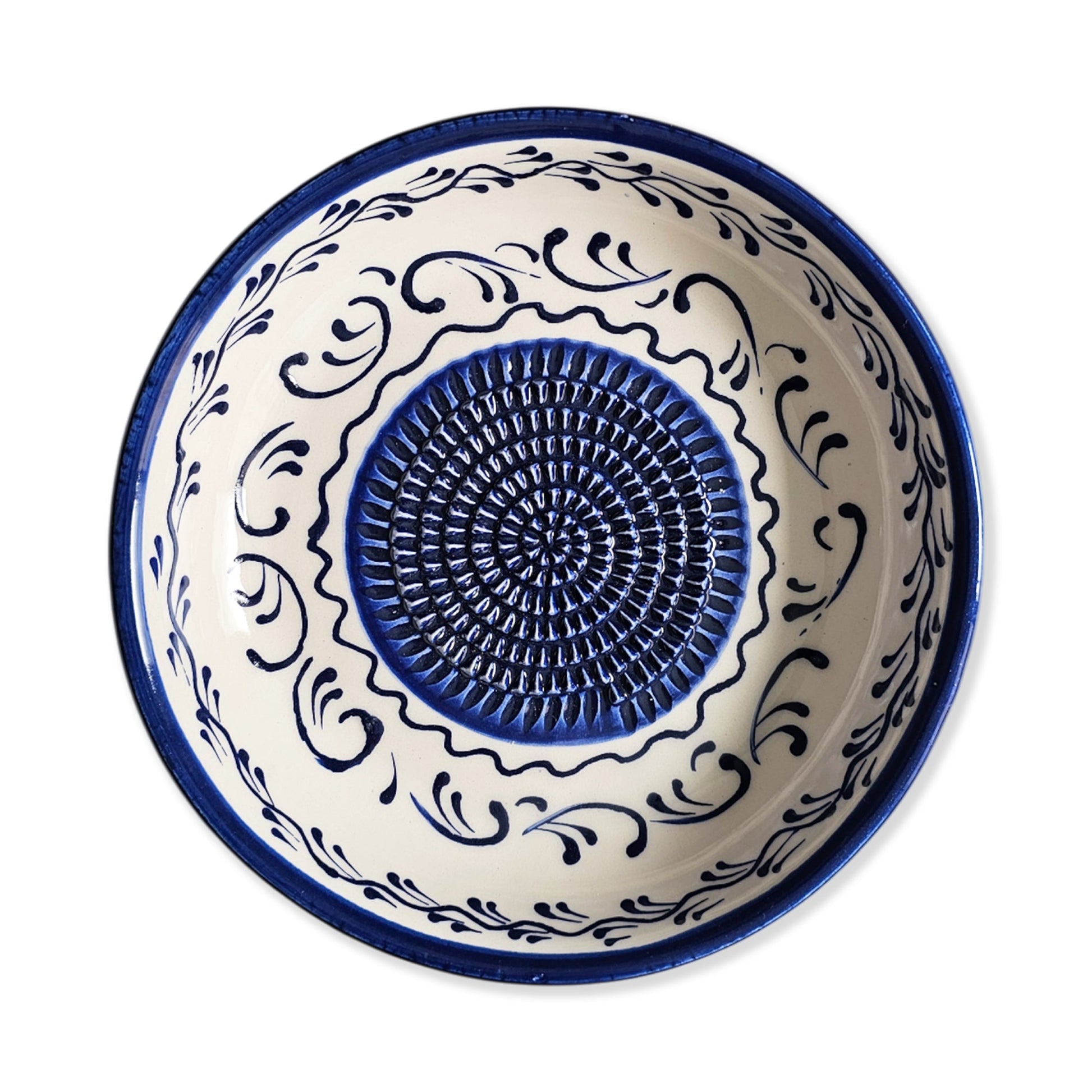 Ceramic garlic grater bowl with blue and white decorative patterns on a white background