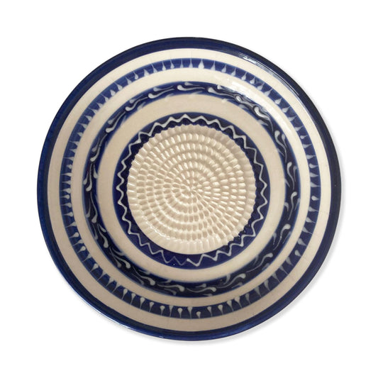 Ceramic garlic grater bowl with blue and white pattern on a white background