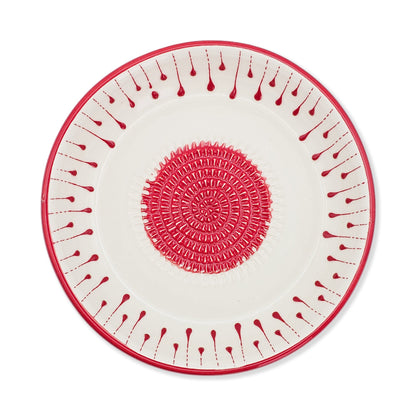 Decorative garlic grater bowl with red and white pattern on a white background