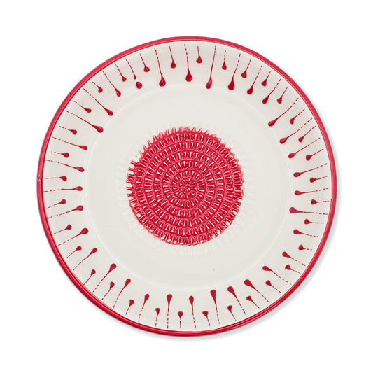 Decorative garlic grater bowl with red and white pattern on a white background