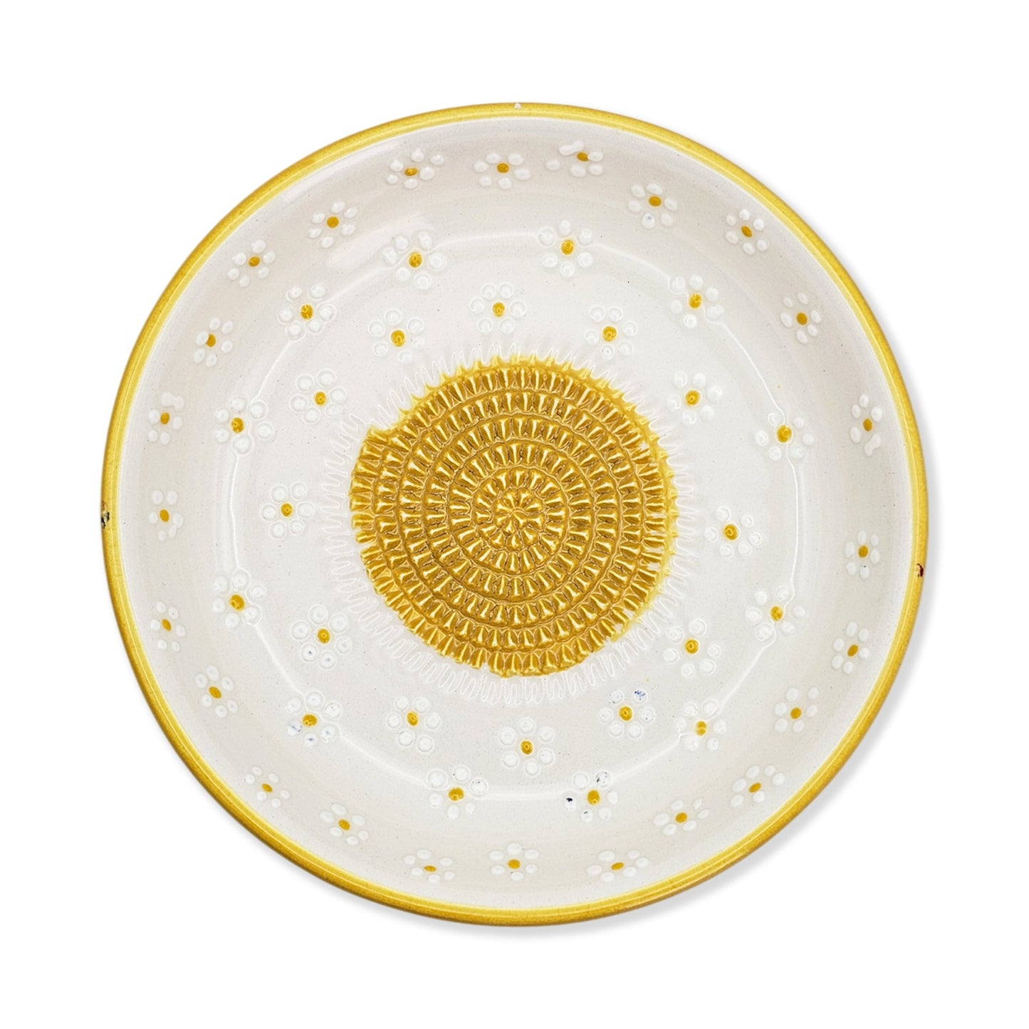 Decorative garlic grater bowl with yellow polka dots and center design on a white background