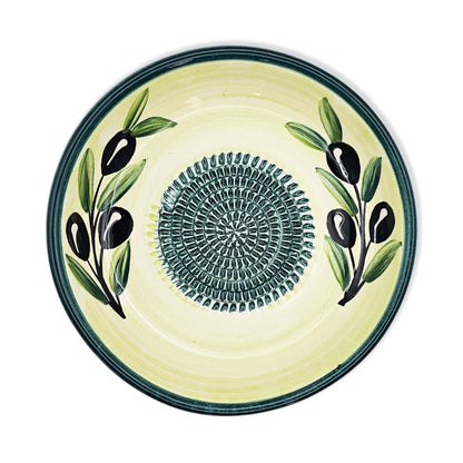 Ceramic garlic grater bowl with olive design on a white background