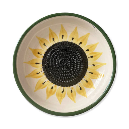 Ceramic garlic grater bowl with sunflower design on a white background