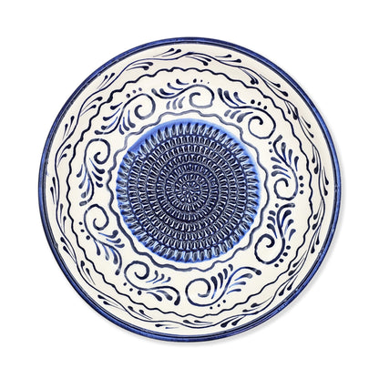 Ceramic garlic grater bowl with blue and white decorative patterns on a white background