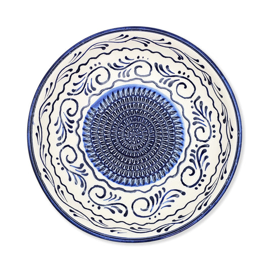 Ceramic garlic grater bowl with blue and white decorative patterns on a white background