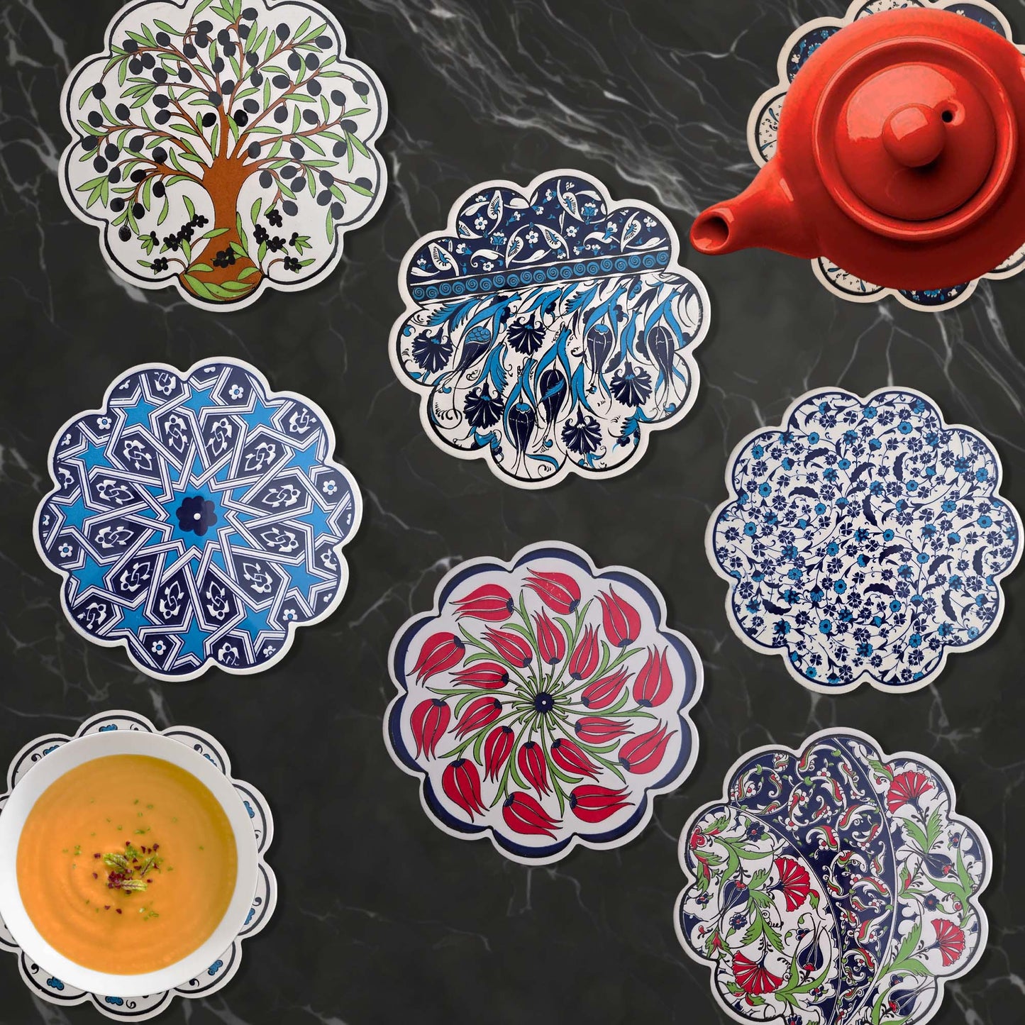 Decorative trivets with intricate designs on a dark surface.