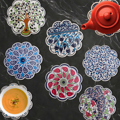Decorative trivets with intricate designs on a dark surface.