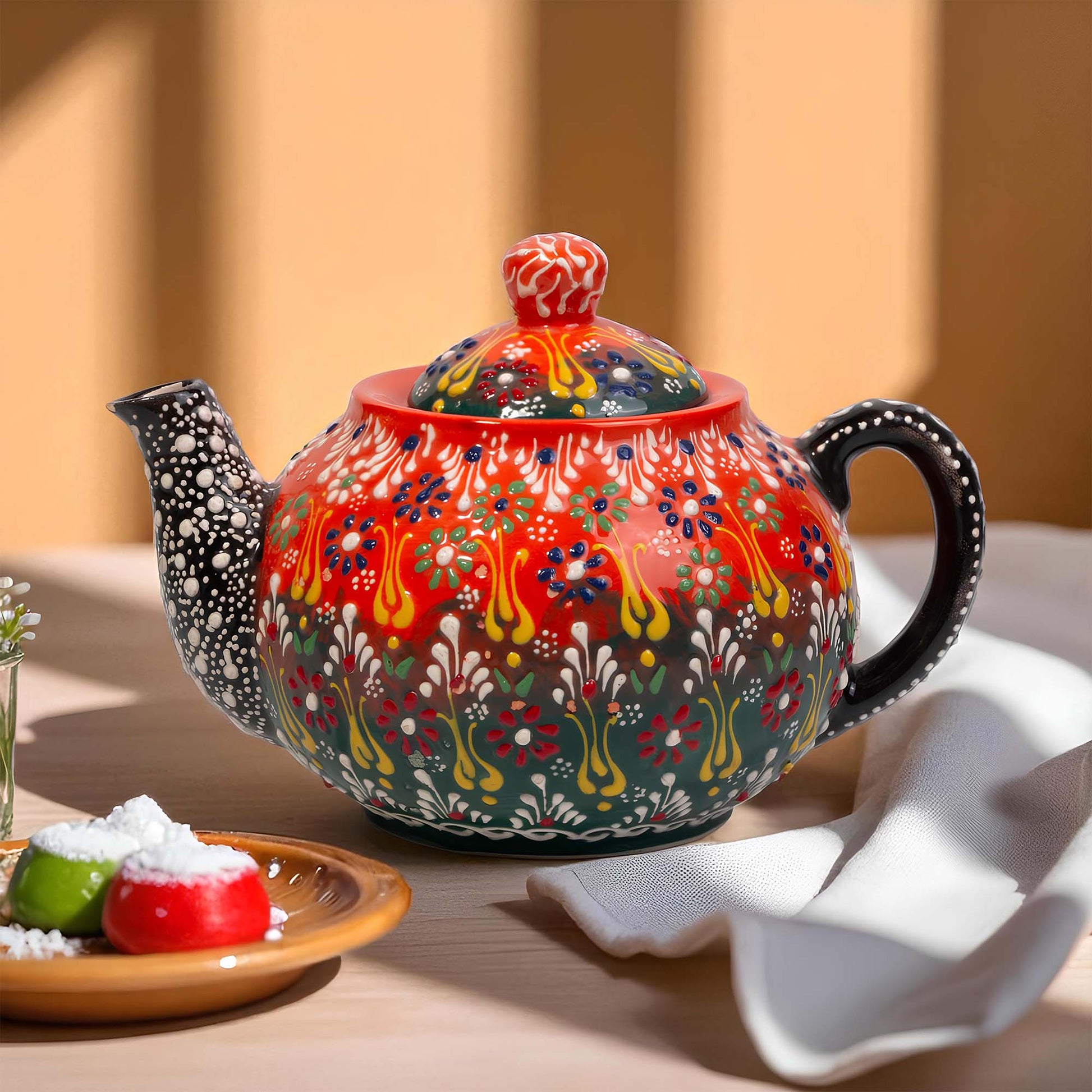 Colorful ceramic teapot with intricate patterns on a wooden table.