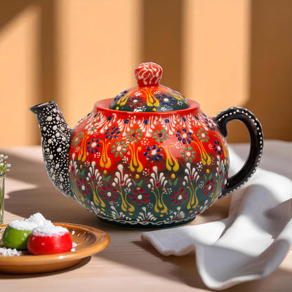 Colorful ceramic teapot with intricate patterns on a wooden table.