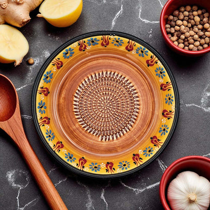 Handmade ceramic garlic grater bowl in Saffron Petals design. Large 7” size, perfect for garlic, ginger & spices. Bright artisan style, dishwasher safe.