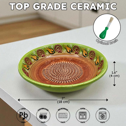 Decorative ceramic garlic grater bowl with green rim and brown center on a white surface, with measurements and safety icons displayed.