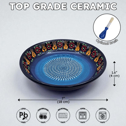 Blue ceramic garlic grater bowl with decorative edge on a white background, featuring dimensions and safety icons.