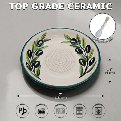 Ceramic garlic grater bowl with olive design on a gray background, featuring dimensions and safety icons.
