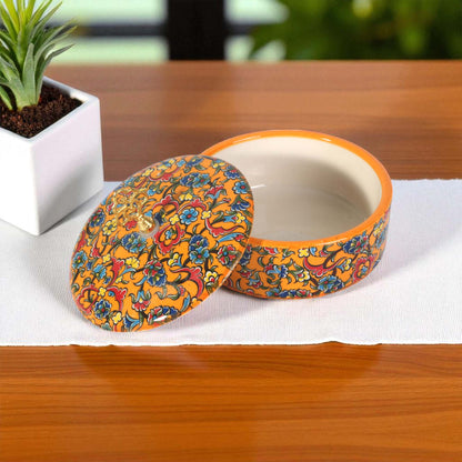 Colorful ceramic sugar bowl with floral design on a wooden table