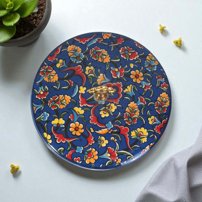 Decorative sugar bowl with colorful floral and dragon design on a white surface.