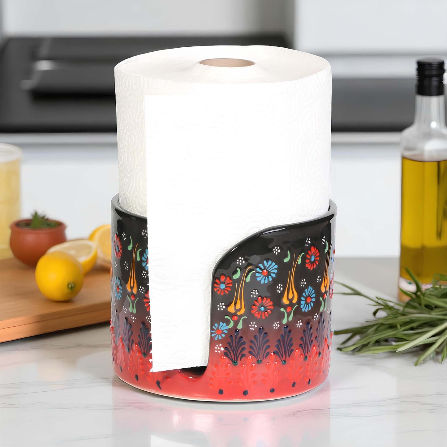 Decorative paper towel holder with a roll of paper towels on a kitchen counter.