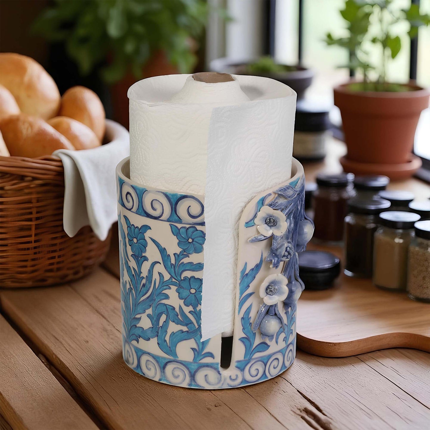 Decorative paper towel holder with blue floral patterns on a kitchen counter.
