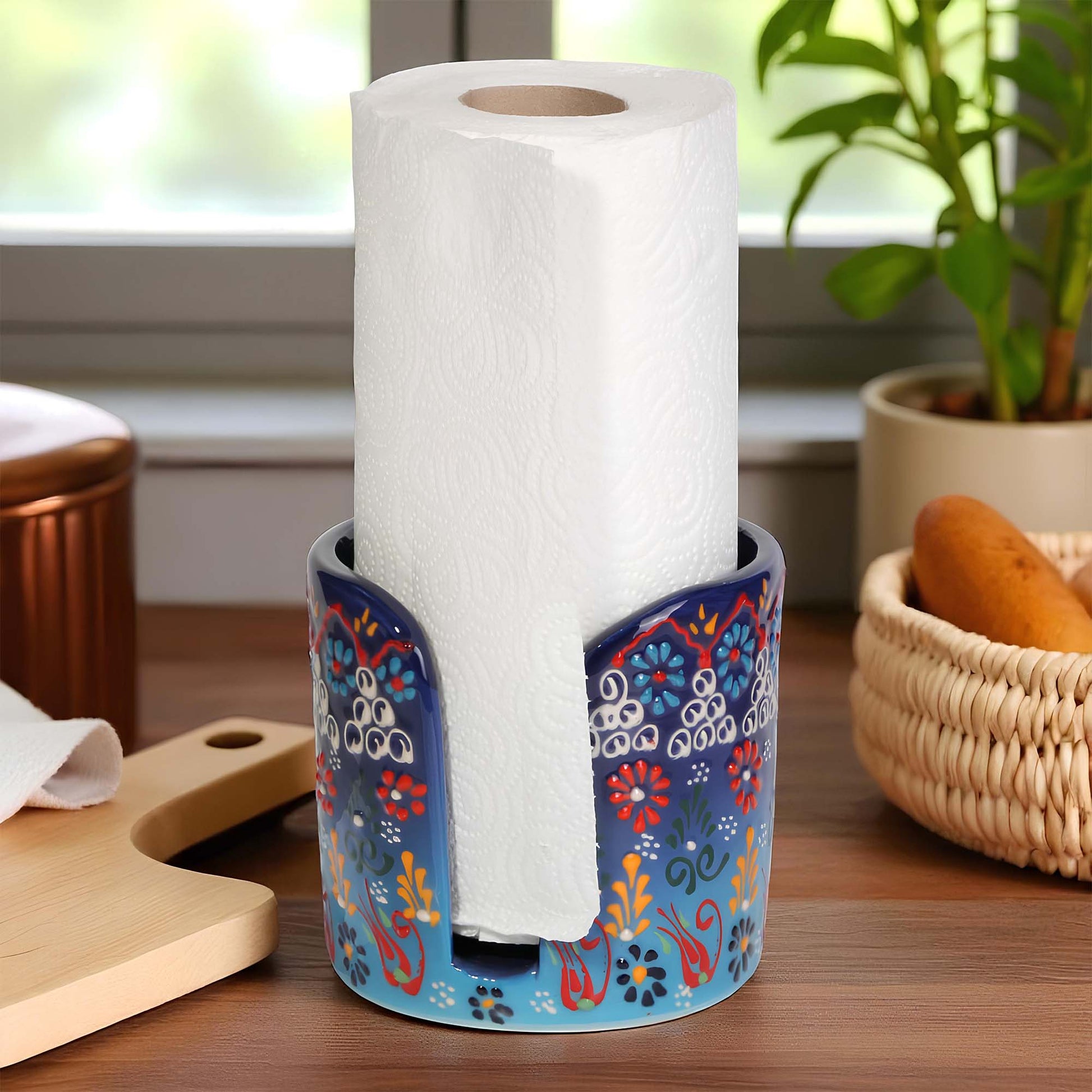 Decorative paper towel holder with a roll of paper towels on a kitchen counter.