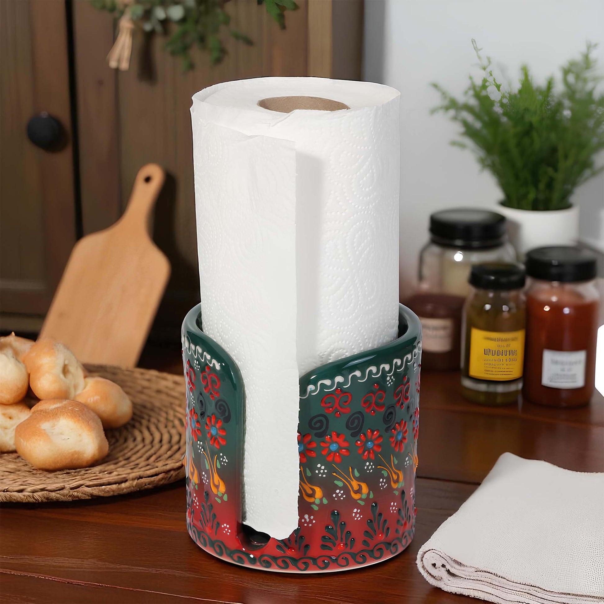 Decorative paper towel holder with a roll of paper towels on a kitchen counter.