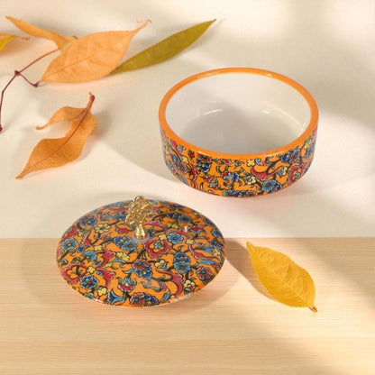 Decorative ceramic sugar bowl with colorful floral pattern on a light background