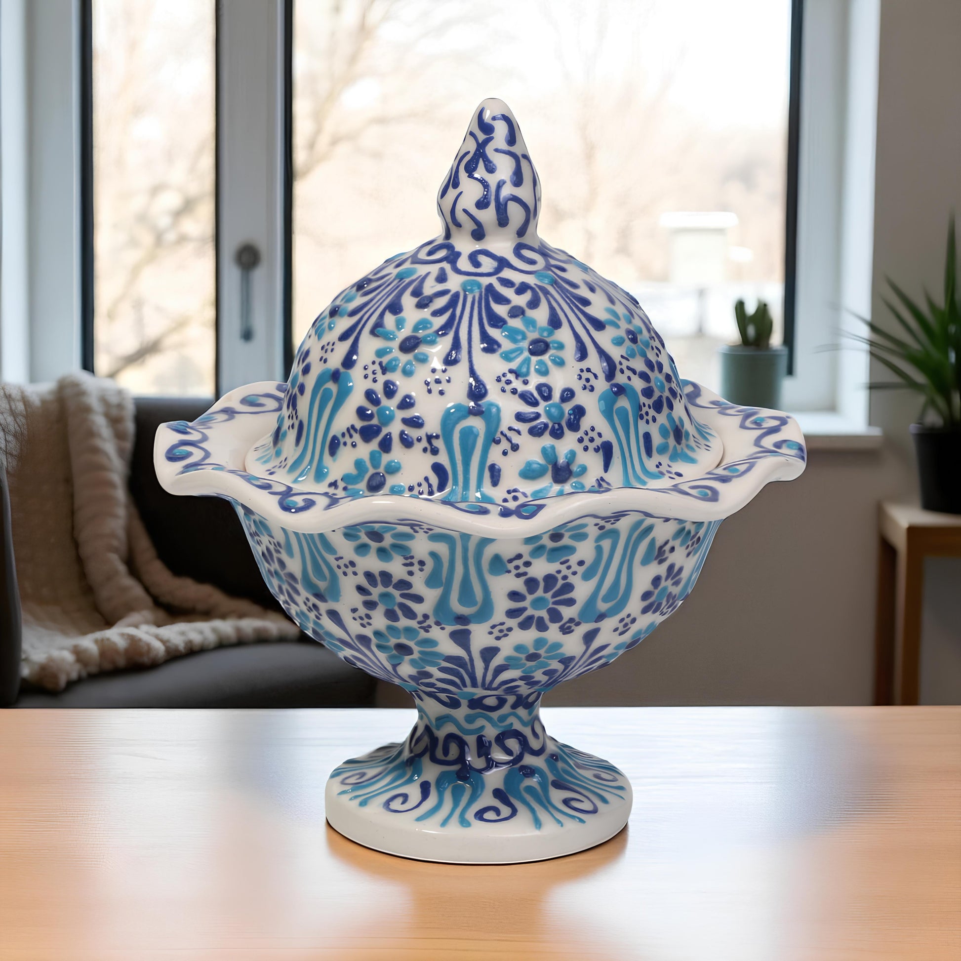 Decorative ceramic sugar bowl with blue and white patterns on a table.