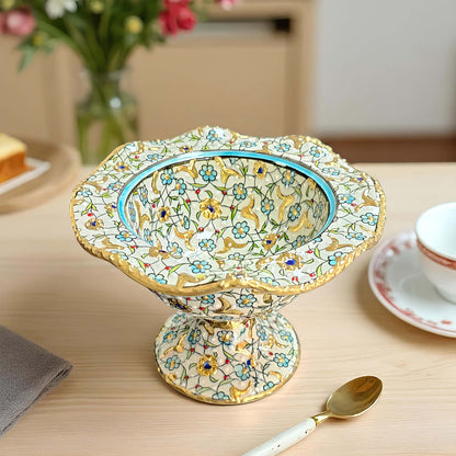 Decorative ceramic sugar bowl with floral patterns on a wooden table.